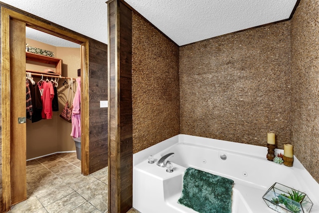 bathroom with a textured ceiling and a tub