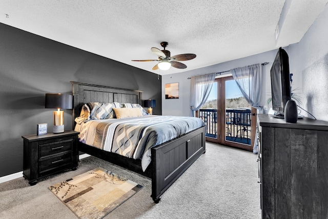 carpeted bedroom with a textured ceiling, access to outside, and ceiling fan