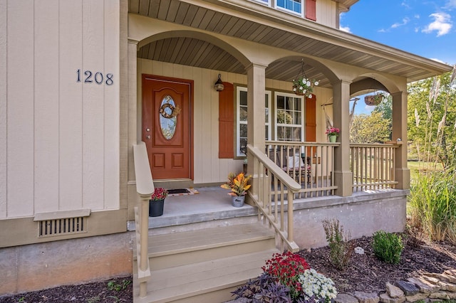 view of exterior entry with a porch