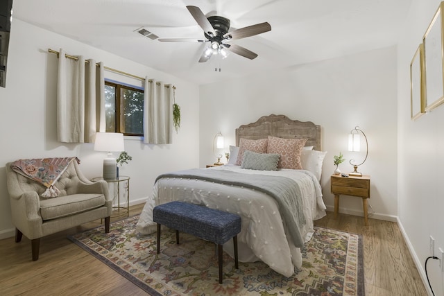 bedroom with wood-type flooring and ceiling fan