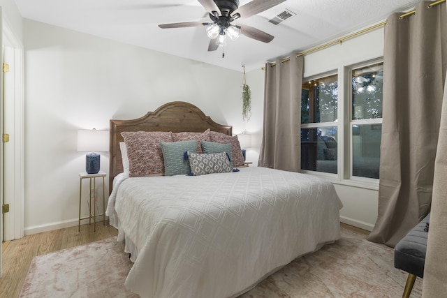 bedroom with ceiling fan and light hardwood / wood-style floors