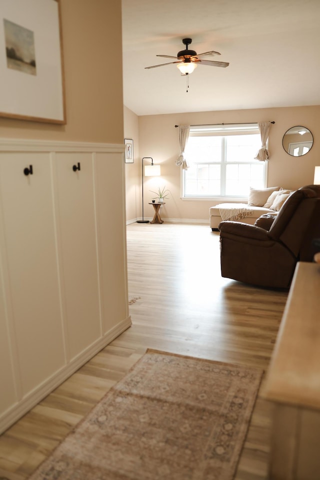 1610 Jon St, West Plains, MO 65775 - corridor featuring light wood finished floors, a wainscoted wall, and a decorative wall