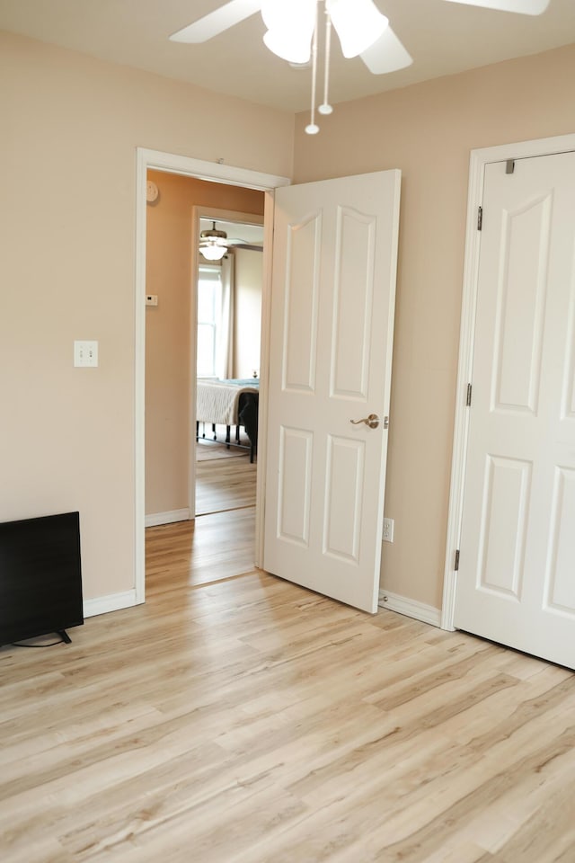 1610 Jon St, West Plains, MO 65775 - unfurnished bedroom with light wood-type flooring, baseboards, and ceiling fan