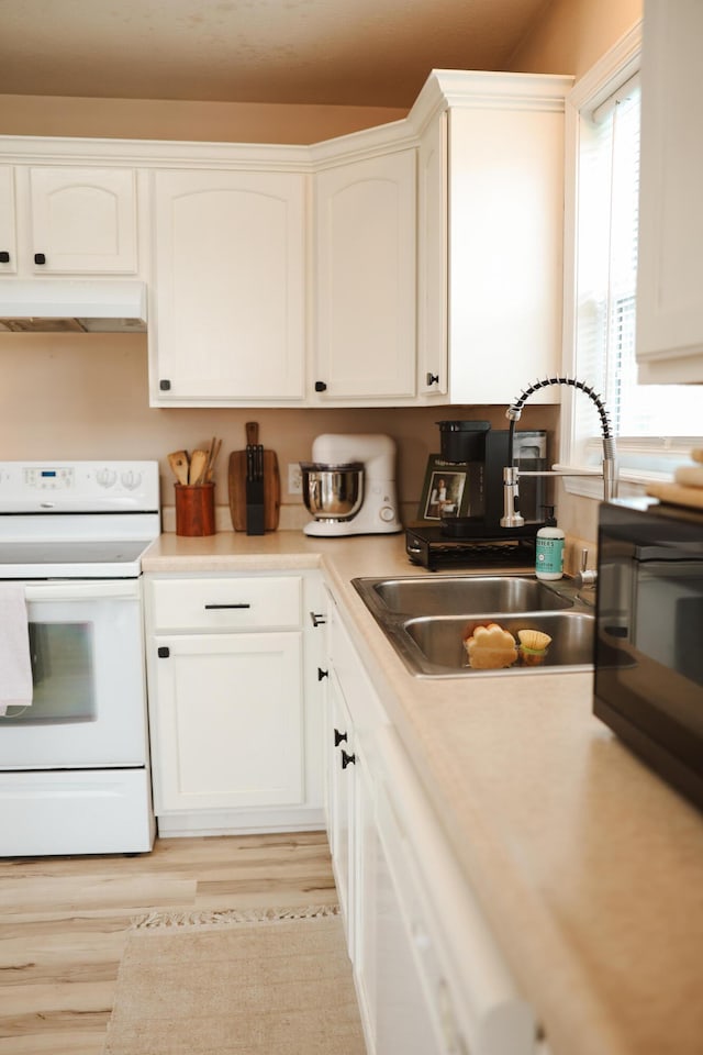 1610 Jon St, West Plains, MO 65775 - kitchen featuring white range with electric stovetop, under cabinet range hood, a sink, and white cabinets
