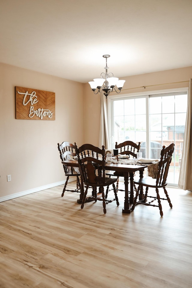 1610 Jon St, West Plains, MO 65775 - dining area featuring light wood finished floors, a chandelier, and baseboards