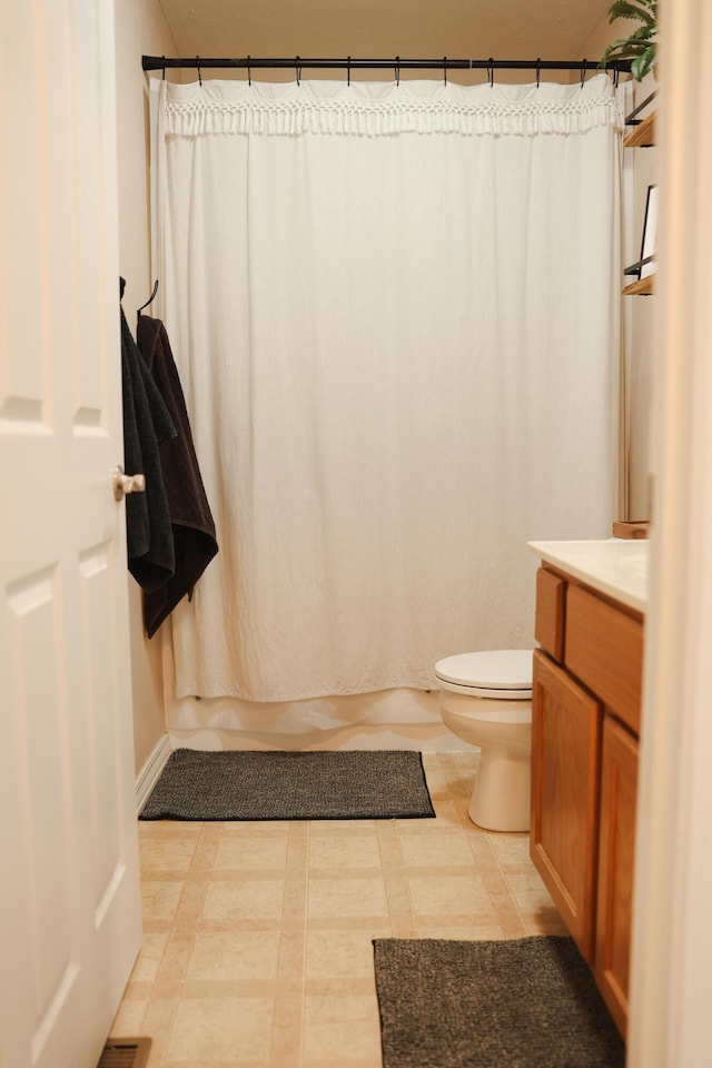 1610 Jon St, West Plains, MO 65775 - bathroom with toilet, vanity, and baseboards