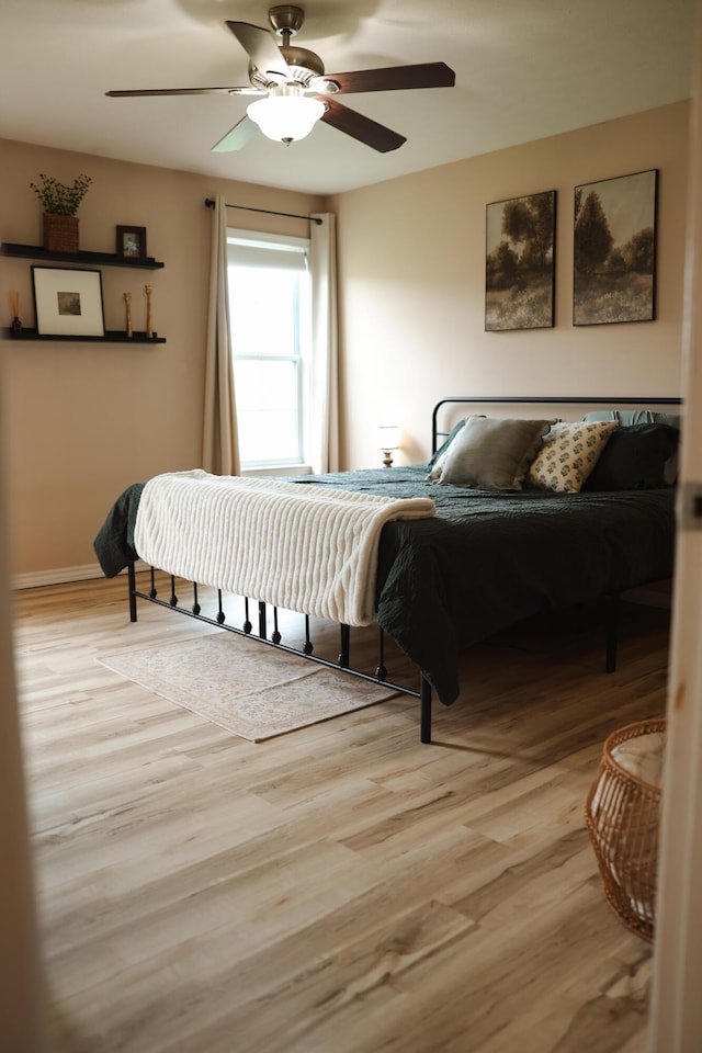 1610 Jon St, West Plains, MO 65775 - bedroom featuring light wood finished floors, a ceiling fan, and baseboards