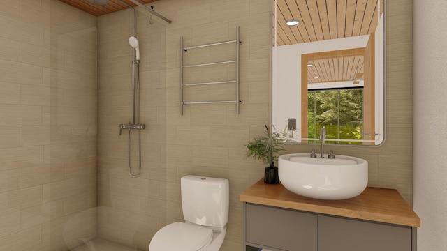 bathroom featuring sink, tiled shower, tile walls, and toilet