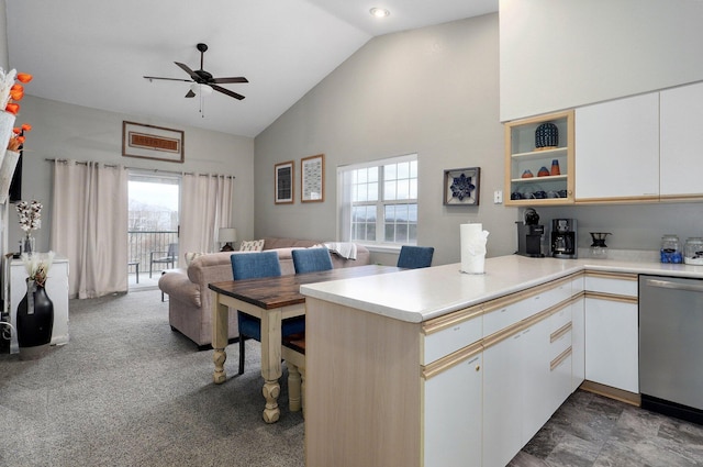 kitchen with dishwasher, kitchen peninsula, and white cabinets