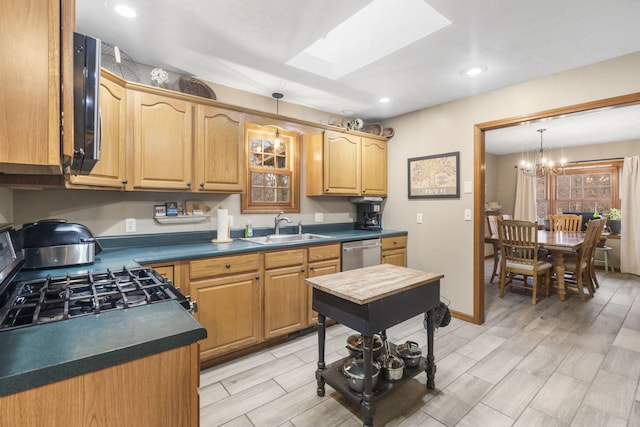 kitchen with sink, range with gas cooktop, decorative light fixtures, a skylight, and stainless steel dishwasher