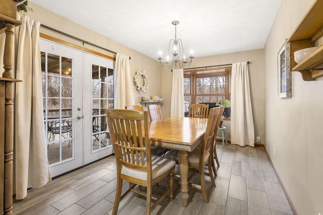 dining area with a chandelier and french doors