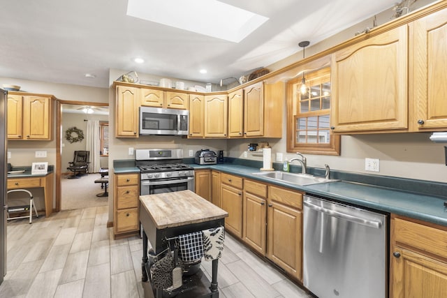 kitchen featuring wood counters, sink, decorative light fixtures, a skylight, and stainless steel appliances