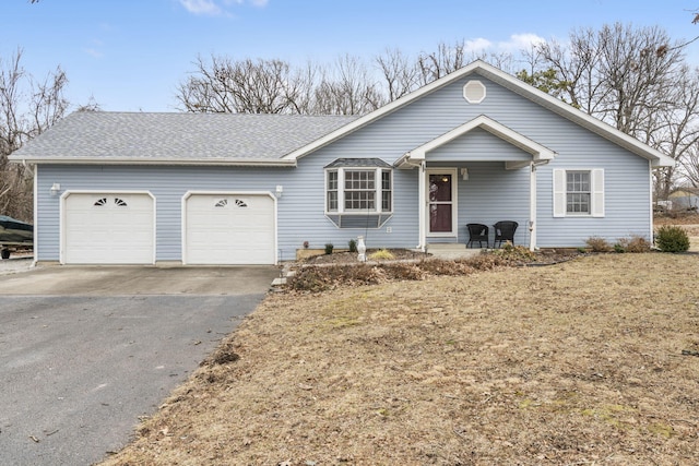 ranch-style home with a garage and a porch