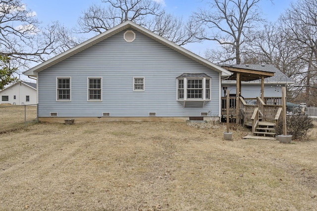 rear view of property featuring a lawn