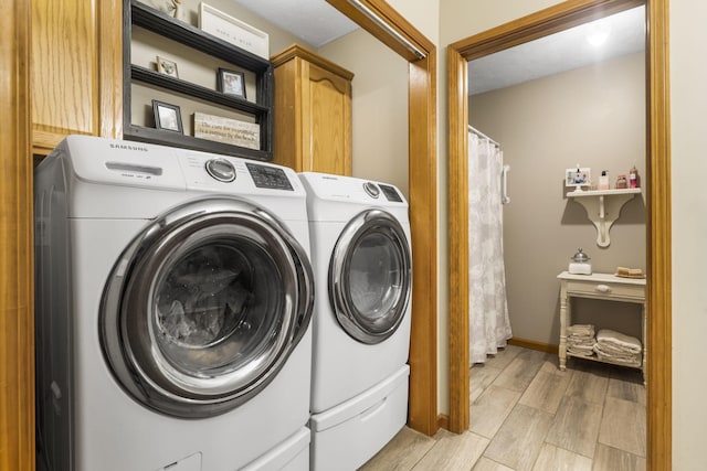 laundry area featuring cabinets and washing machine and dryer