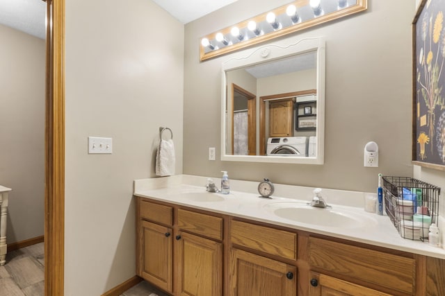 bathroom featuring vanity and washer / clothes dryer