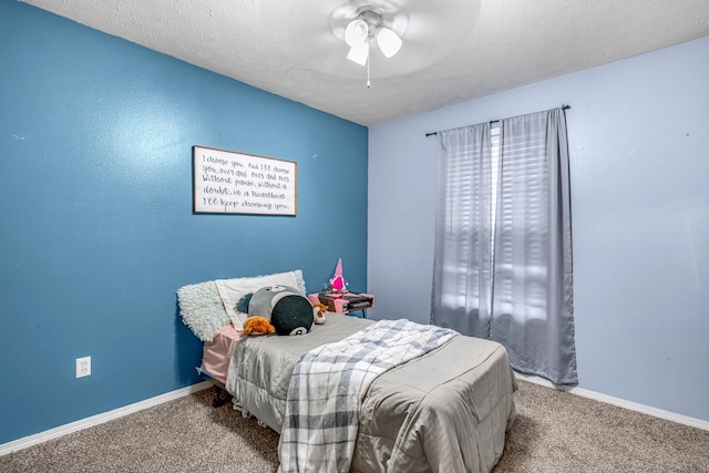 carpeted bedroom with ceiling fan and a textured ceiling