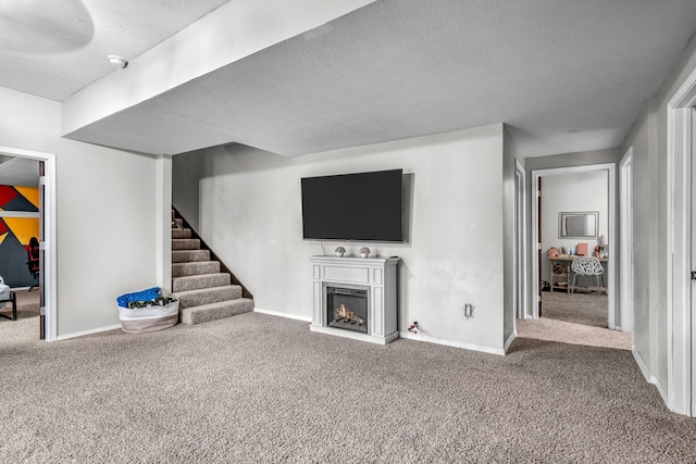 unfurnished living room with carpet flooring and a textured ceiling