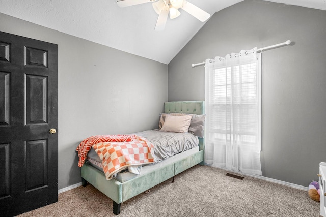 bedroom featuring ceiling fan, vaulted ceiling, and carpet