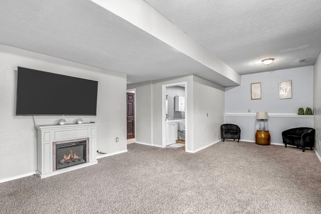 unfurnished living room featuring carpet and a textured ceiling