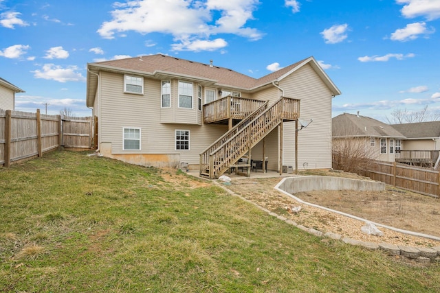 rear view of property with a yard and a deck