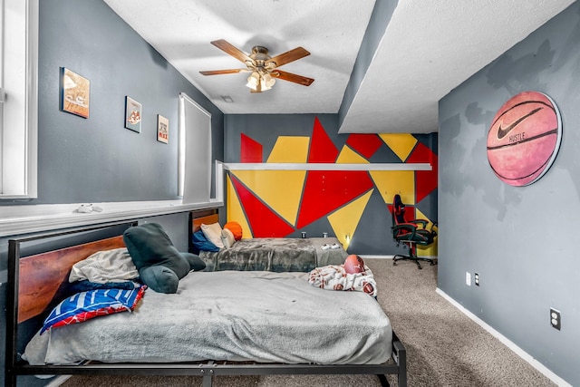 carpeted bedroom featuring ceiling fan and a textured ceiling