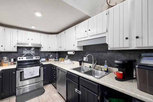 kitchen with stainless steel appliances, tasteful backsplash, sink, and white cabinetry