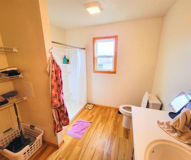 bathroom with toilet, hardwood / wood-style floors, vanity, and a shower with curtain