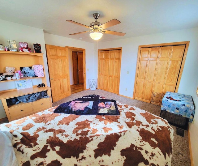 bedroom featuring multiple closets, carpet, and ceiling fan