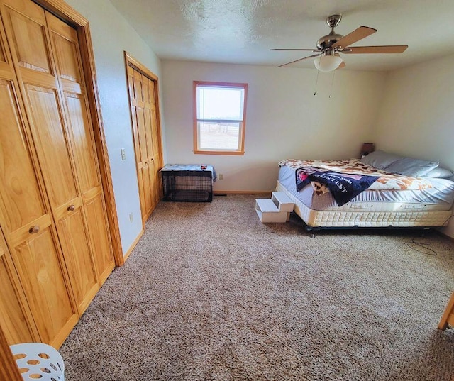 bedroom featuring ceiling fan, carpet flooring, and a textured ceiling