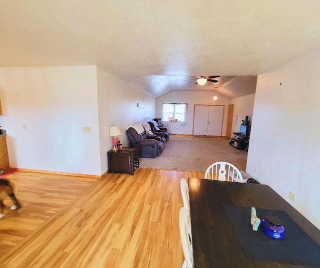 dining area featuring hardwood / wood-style flooring, vaulted ceiling, and ceiling fan
