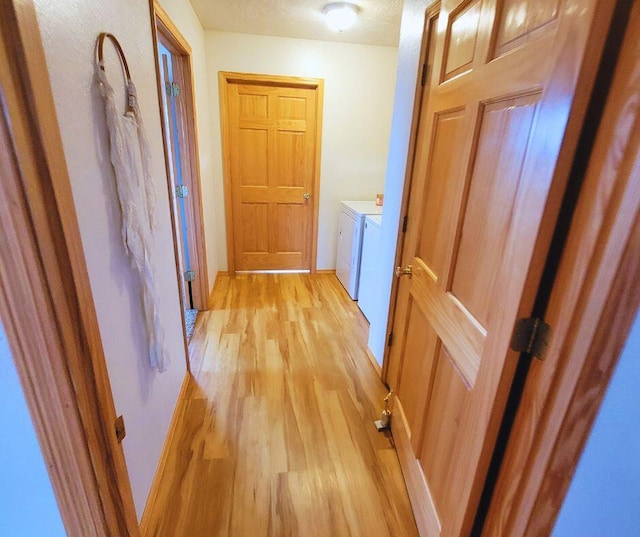 hall featuring washer and clothes dryer and light wood-type flooring