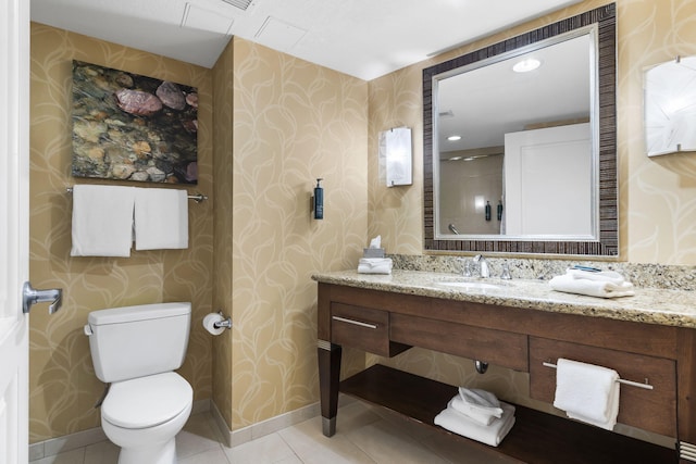 bathroom with tile patterned flooring, vanity, and toilet