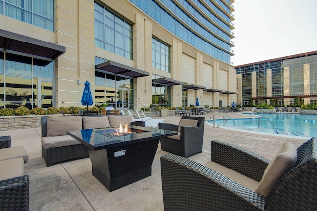 view of patio / terrace featuring a community pool and an outdoor fire pit