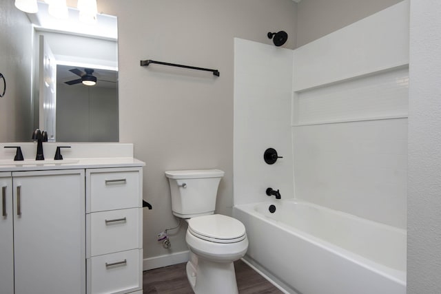 bathroom with vanity, baseboards, toilet, shower / bathing tub combination, and wood finished floors