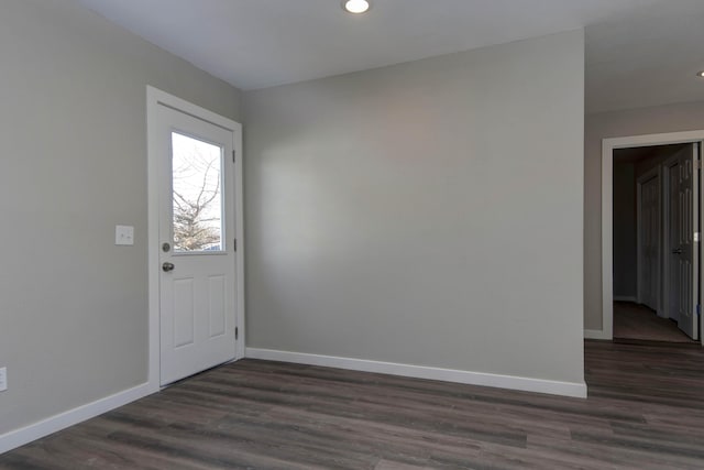 entrance foyer with dark wood-style flooring, baseboards, and recessed lighting