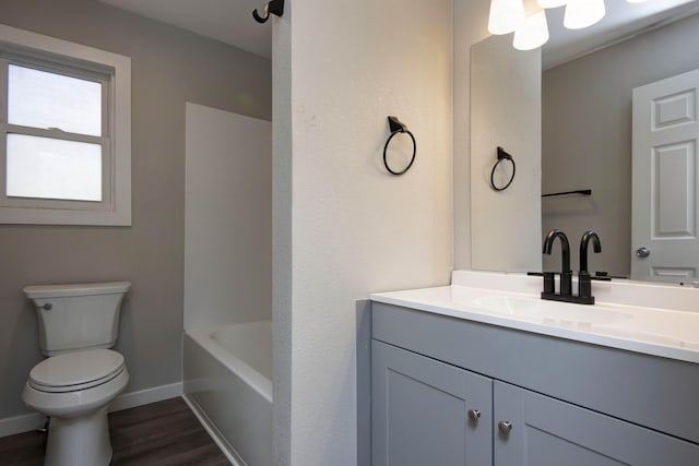 full bathroom with vanity, a bathing tub, toilet, a shower, and wood finished floors