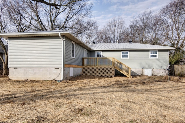 back of property featuring metal roof, crawl space, and a deck