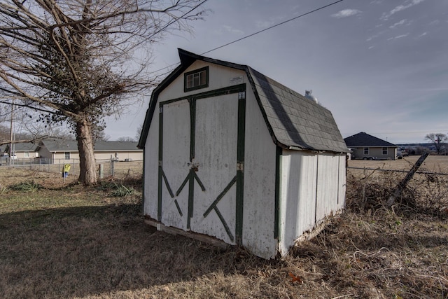 view of shed featuring fence