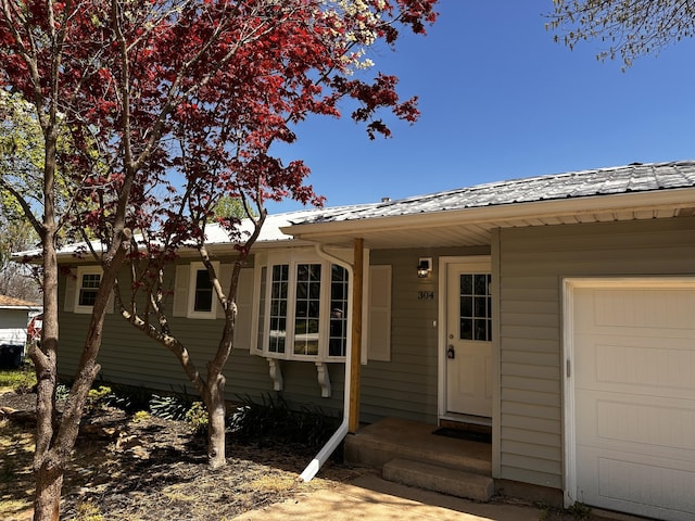 doorway to property with a garage