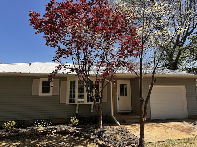 ranch-style home with a garage and driveway