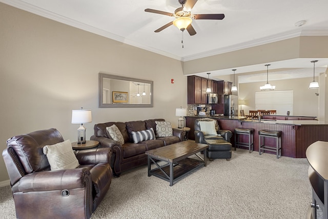 living area featuring ornamental molding, a ceiling fan, and light colored carpet