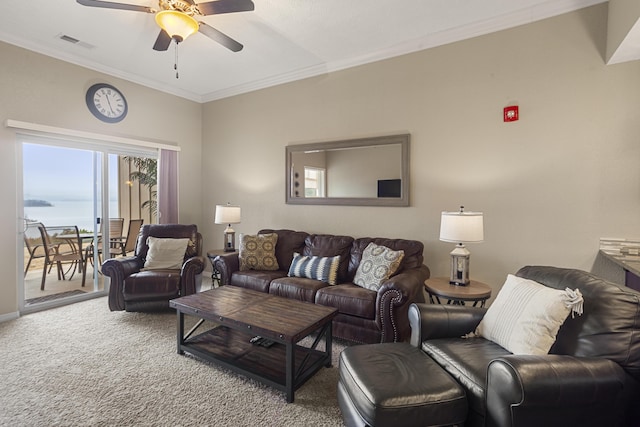 carpeted living area with ornamental molding, visible vents, and a ceiling fan