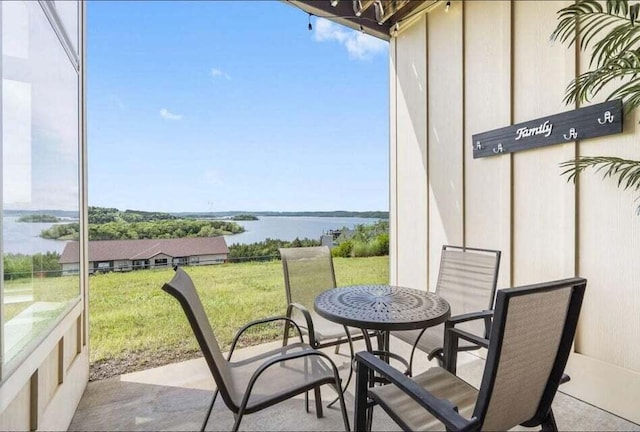 balcony featuring a water view and a patio