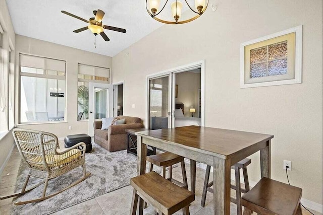 sunroom / solarium featuring ceiling fan with notable chandelier