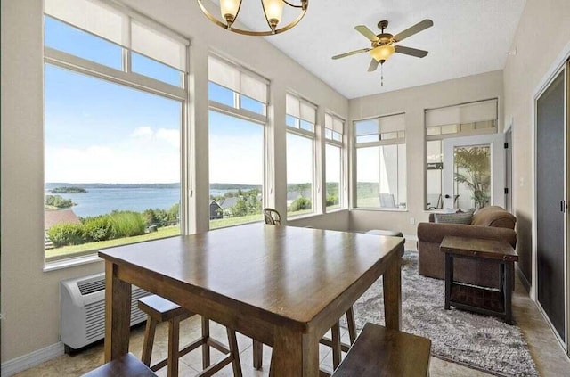 sunroom / solarium featuring a water view and ceiling fan with notable chandelier