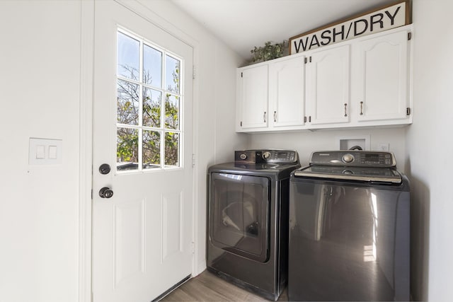 washroom featuring cabinets, wood-type flooring, and independent washer and dryer