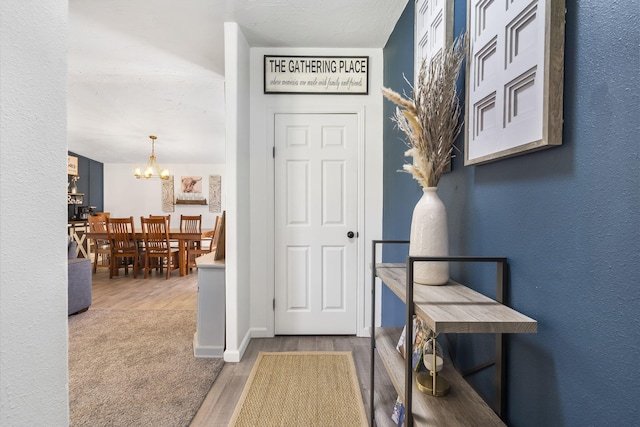 entrance foyer featuring wood-type flooring and a notable chandelier