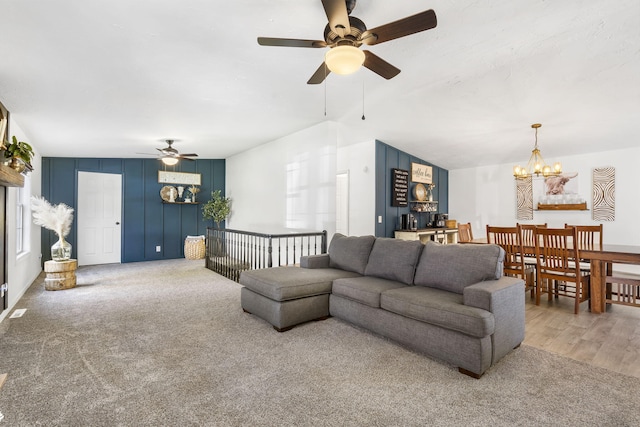 carpeted living room featuring plenty of natural light and a chandelier