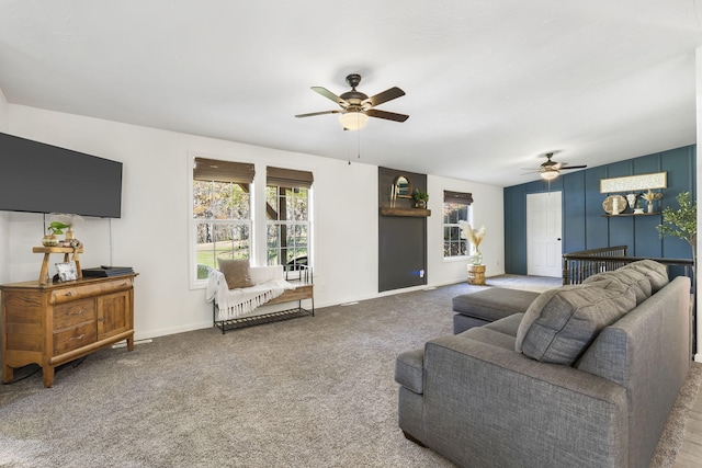 carpeted living room with ceiling fan